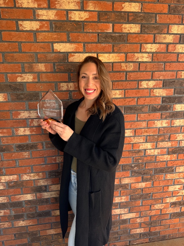 Brandi Rininger holding her 2025 Rookie of the Year award from the Carolina Smokies Association of Realtors